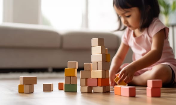 Kid playing with colorful wooden toy blocks. Little boy or girl building tower of block toys. Educational and creative toys and games for young children. Baby in white bedroom with rainbow bricks. Child at home. Copy space Space for text