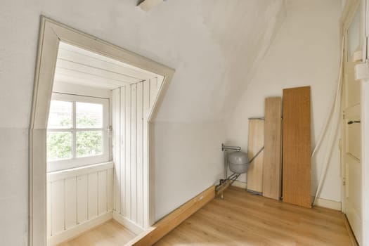 an empty room with wood flooring and white paint on the walls, there is a mirror in the corner