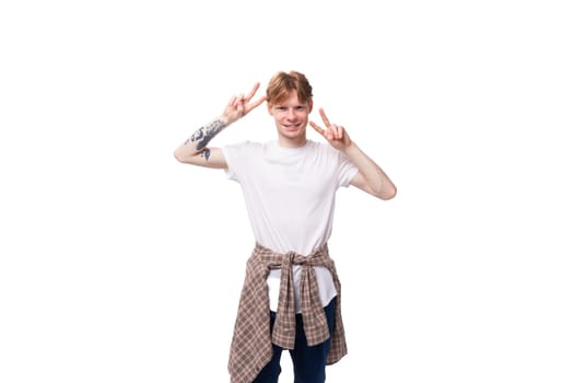 young cheerful positive european male student with golden red hair wearing glasses on white background.