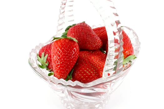 Strawberries in a glass basket isolated on white