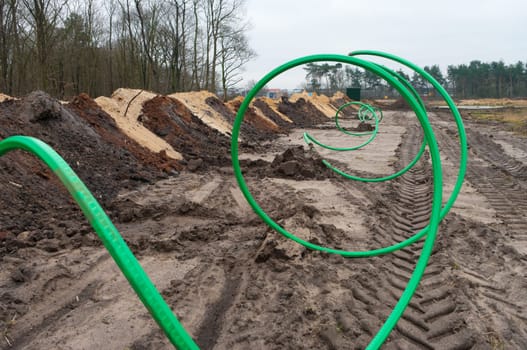 green fiber cable ready to go into the ground on a newly build industrial area