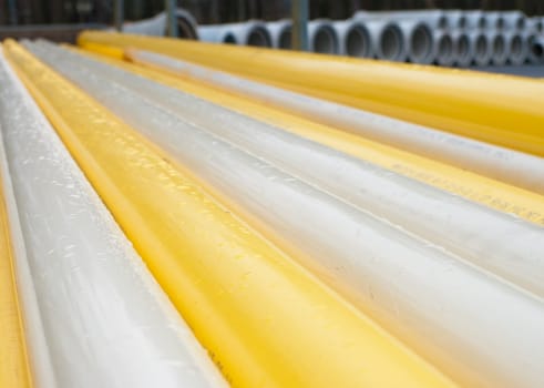 stacked yellow pvc pipes