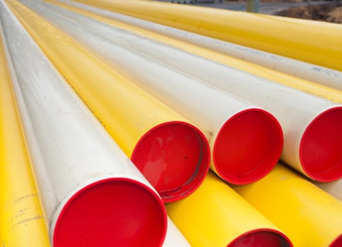 stacked yellow pvc pipes