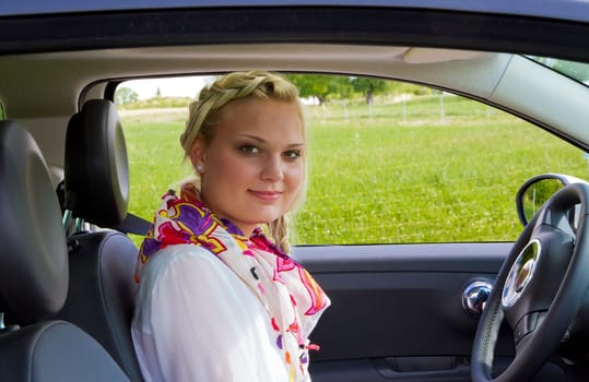 Young businesswoman in car