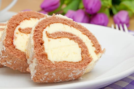 Swiss Sponge Roll With Cream on White Plate - Shallow Depth of Field