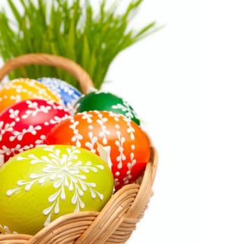 Easter Hand Painted Eggs in Basket and Grass Isolated on White