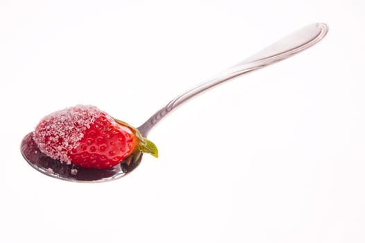 Strawberry in sugar served on a spoon