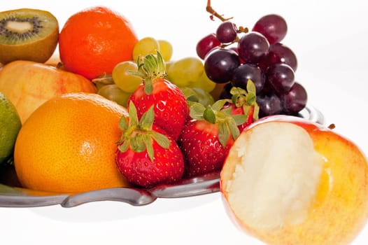 Composition of fresh fruit on the decorative metal tray.