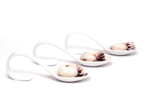 Three spoons of porcelain with cuttlefish squid