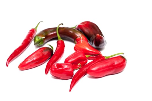 Various peppers and chili are isolated in white