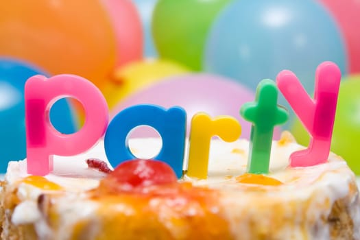 "PARTY"" word , birthday cake and colorful balloons"