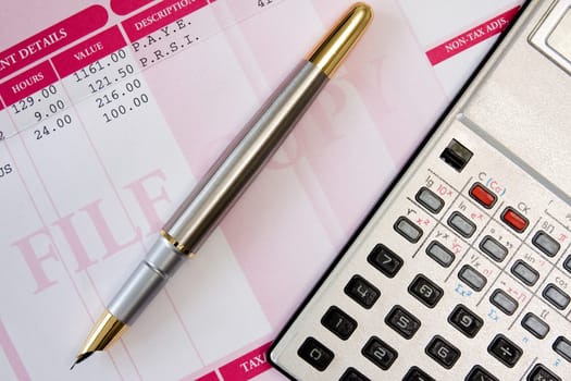 ink pen,calculator  and payroll summary details