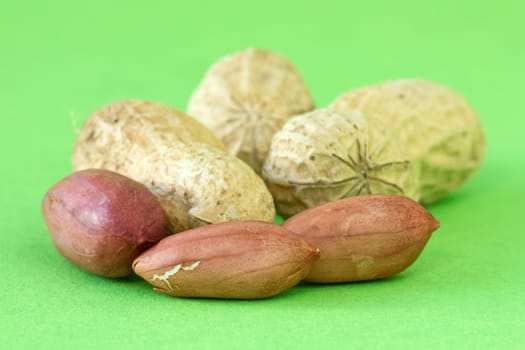 pile of peanuts over a green background