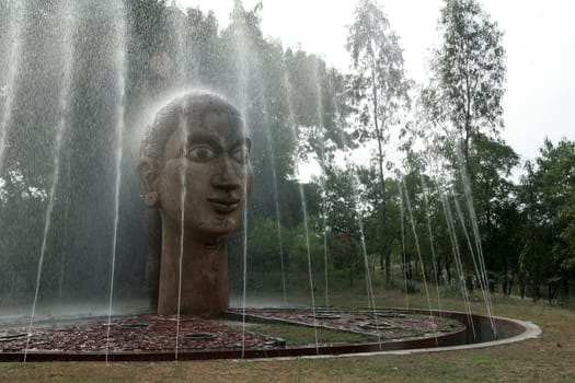 Shower wash of head by multiple jets of a fountain in a park