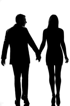 rear view one lovers caucasian couple man and woman walking hand in hand in studio silhouette isolated on white background