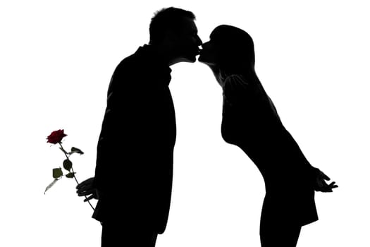 one caucasian couple man and woman kissing in studio silhouette isolated on white background