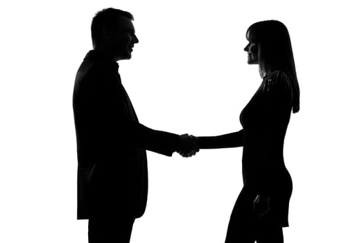 one caucasian couple man and woman handshake in studio silhouette isolated on white background