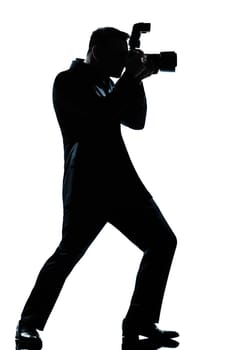 one caucasian man photographer full length silhouette in studio isolated white background