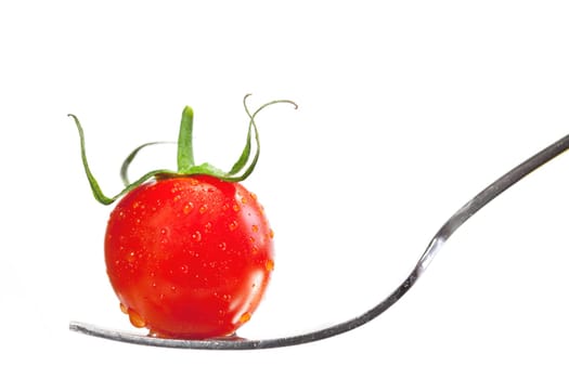 Tomato on a fork isolated on white