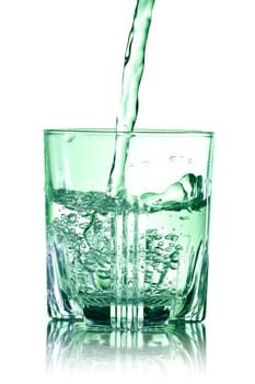 Glass of pouring water with reflection on white background