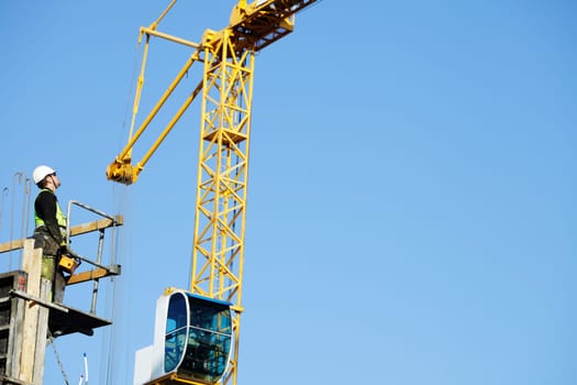 crane-driver, remote controling large construction crane