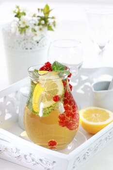 Refreshing summer ice tea or lemonade with fresh fruits