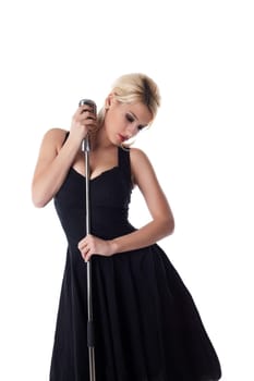 beauty woman pin-up portrait in black dress with microphone isolated