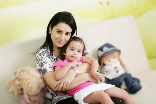 Mother and daughter in the waiting room at doctors office.