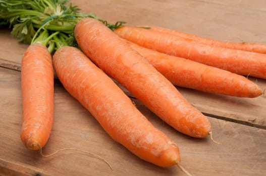 Bunch of Raw Carrots on Aged Wooden Table