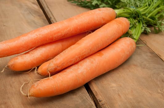 Bunch of Raw Carrots on Aged Wooden Table