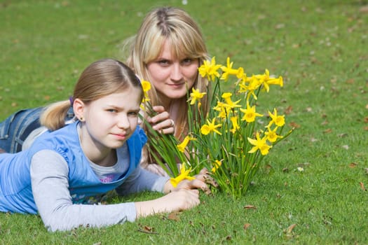 young woman and little girl in the park on a warm spring day
