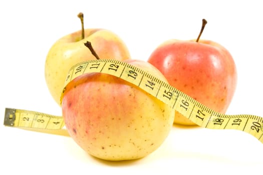 healthy life concept.apples and measure tape over white background.