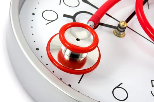 healthy lifestyle. red stethoscope on silver clock