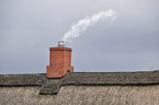 Chimney on thatched roof