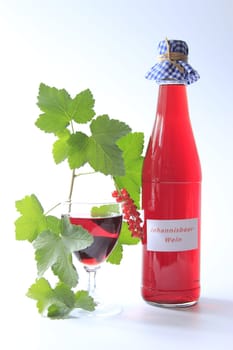Red Currant Fruit Wine With Bottle And Glass Isolated Against Neutral Background