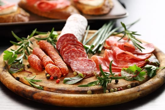 Different Italian ham and salami with herbs