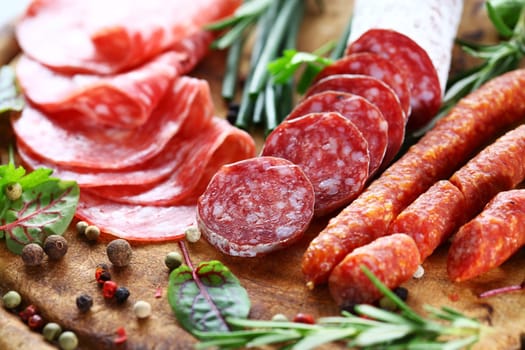Different Italian ham and salami with herbs