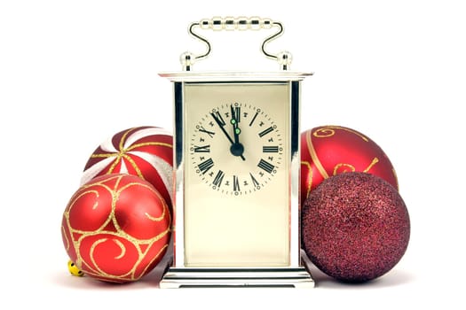five minutes to midnight. christmas baubles and clock
