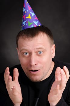 surprised by the man in hat in the dark background