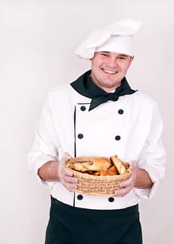 chef keeps basket with buns isolated on white background