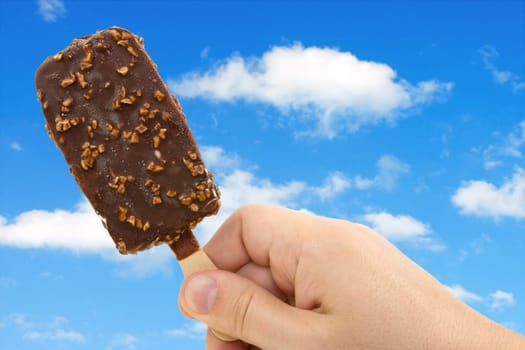 ice cream in the hand over a sky background