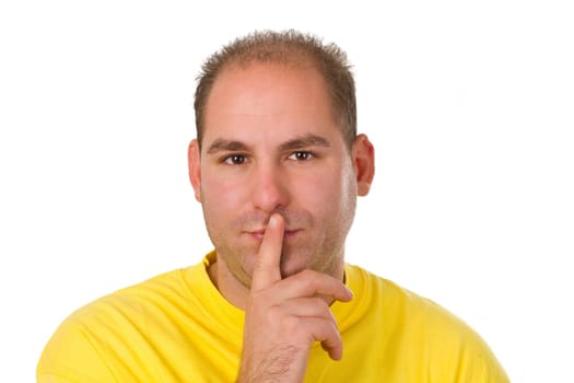 Young man putting finger on mouth - isolated on white background