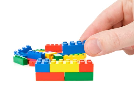 hand build a color plastic  bricks. isolated on white.