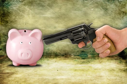financial crisis concept. Piggy bank and hand with gun