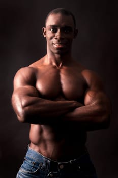 Beautiful and muscular black man in dark background
