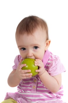 Shot of baby girl on pink eating apple