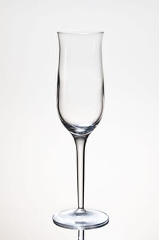 One empty champagne glass isolated on white