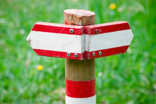 Wooden directional sign pointing to left and right