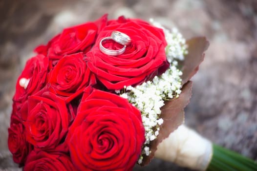 Two wedding rings on a bridal bouqet