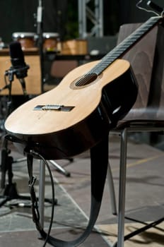 Single concert guitar on the stage waiting to be played